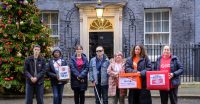 Image protestors outside 10 Downing Street calling for help with the cost of energy outside Big Ben in London.